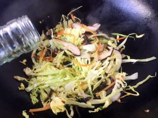 天津特色小吃 蔬菜烩饼,烹入1勺锅沿料酒。