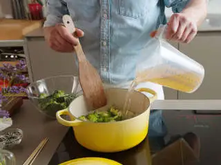 亚洲风味西兰花汤,往大平底锅中倒油，中火加热。放入土豆、蒜和洋葱，然后倒入西兰花茎。撒盐与胡椒调味，煎5-7分钟。倒入蔬菜高汤，微沸15分钟。将烤箱预热至180度。