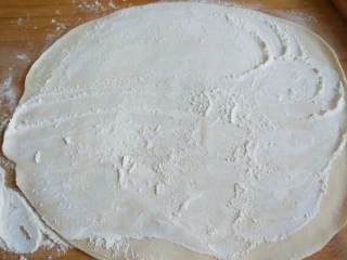 手擀面 北京特色小吃 炸酱面,打开加入干面粉继续擀成薄薄的面皮。