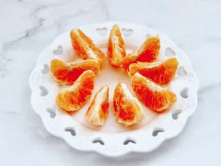 橘子蔓越莓蜂蜜冰饮,橘子去外皮剥出果肉。