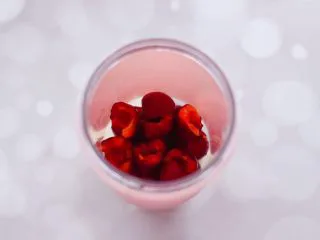 水蜜桃车厘子奶昔,再把去核的车厘子，放入料理杯中。