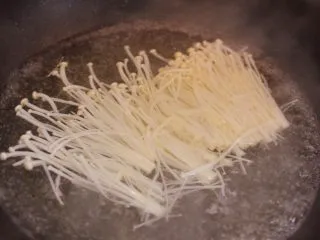 金针酸汤肥牛,金针菇放沸水中焯熟。