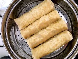 东北风味 蒸千子,把豆卷放入蒸锅，大火烧开后小火蒸制20分钟，千子蒸熟了