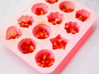 少女风的草莓牛奶冻,草莓丁置入模具中。