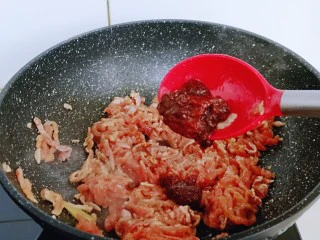 老北京肉丝炸酱面,起油锅，加入腌制好的肉丝翻炒，再加入豆瓣酱，翻炒均匀。