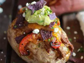 墨西哥风味烤土豆牛排配鳄梨酱,在距离土豆烤熟还有10分钟的时候，加热一个厚底煎锅或铁锅，加入橄榄油(1汤匙)，加热1分钟。