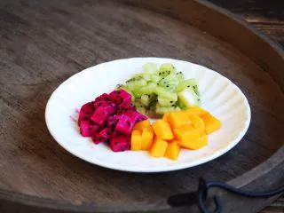 百变水果 三色水果银耳粥,将准备好的三色水果放入银耳粥的碗里，水果的量随意。