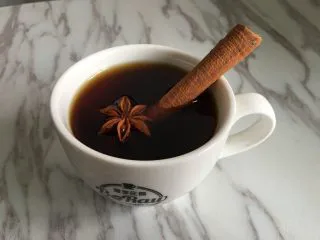 原创|热带雨林圣诞咖啡,将萃取好的咖啡加入咖啡杯，并放入香料进行装饰；