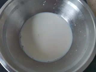 蔓越莓冰激凌,牛奶倒入奶锅中,加热至微微起泡,即可关火