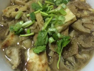 自制老北京小吃【卤煮】,如图在碗里加入少许的香醋,撒上香葱香菜末即可