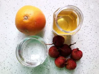 蜂蜜荔枝西柚汁,首先我们准备好所有食材:西柚一只(300g左右,去皮之后实际用量为190g左右),荔枝六颗(去皮去核之后实际用量为110g左右),饮用水120g左右,蜂蜜1-2勺