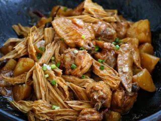 鸡翅腐竹烧土豆,待锅内食材炖至软烂,按照个人口味调入适量的盐翻炒收汁,再撒入少许葱花点缀即可