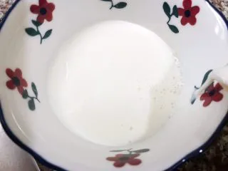 清火滋补之莲子双皮奶,再从边缘把牛奶倒回碗里