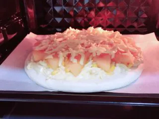 蜜瓜蔬果披萨,烤箱提前预热,180度预热5分钟。将烤盘放入烤箱中,200度烤10分钟。