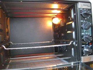 芋泥肉松泡芙,将烤盘放入烤箱,上下火180度预热