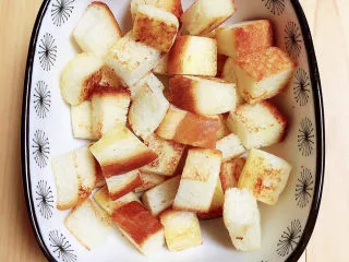 鸡蛋牛奶布丁,将香煎好的面包块放入烤碗中。