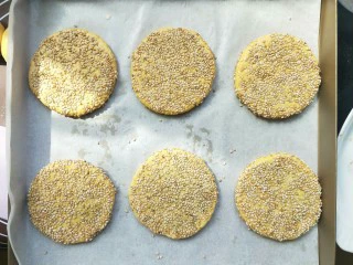 南瓜糯米夹心饼,依次做好，摆入烤盘，上面用喷壶喷一些水雾，防止烤干。上下火。170度。25分钟，翻面。再烤五分钟。每个人烤箱温度不同，根据习性上下调整。 