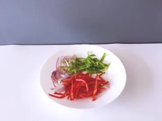 西餐之黑椒鸡丝意大利面,将红辣椒洗净切丝，青椒洗净后切丝，洋葱洗净切丝