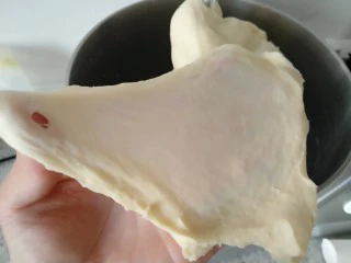 手撕海苔肉松面包,取一小块面团可以拉出粗膜即可。