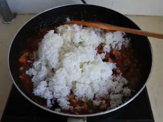 茄汁培根焗饭,倒入米饭拌匀，撒芝士粉拌匀