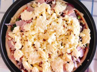 芝士培根披萨,再铺上一层芝士碎。