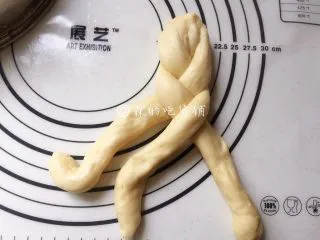 一发的淡奶油辫子面包,然后就像麻花辫一样把它编起来，记得编紧一点，底部尽量编到不能编的程度，也捏紧捏牢。