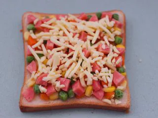 田园时蔬吐司披萨,最后撒上芝士碎。