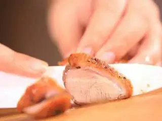 法式香橙煎鸭胸 ,取出烤好的鸭胸肉,切成片,摆入盘中。