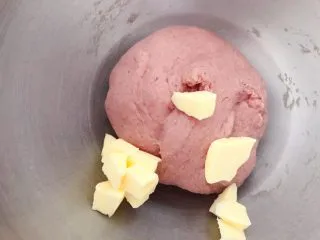 猪猪椰蓉小面包,搅打成光滑面团后，放入室温软化的黄油，继续低速搅打，黄油和面团融合后，厨师机高速打发。