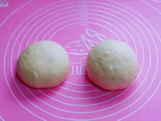 罗勒意式披萨,发酵好的面团分两个面团，盖上保鲜膜醒发10分钟。