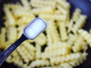 炸锅版狼牙薯条,加入适量的盐,这样炸出来的薯条和色泽都很好。