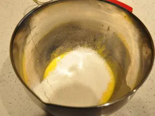 日式豆乳盒子蛋糕,将低筋面粉全部过筛加入到蛋黄糊中。