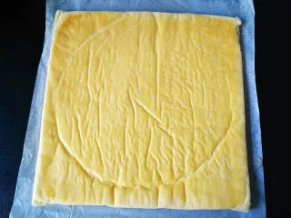 椰蓉蜂蜜蛋糕卷,稍凉倒扣在一张油纸上，撕开表面油纸