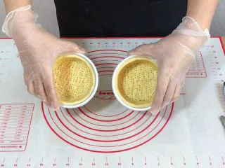 外酥里嫩的~爆浆芝士塔,用刀子切去多余塔皮,并用叉子在底部插孔。放入冰箱冷藏10分钟左右定型。